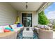 Covered patio with a modern gas fire pit, comfortable seating, and sliding glass doors at 5964 E 141St Ave, Thornton, CO 80602
