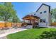 Backyard featuring an outdoor patio with a pergola, a fire pit area, and green lawn space at 1911 S Lafayette St, Denver, CO 80210