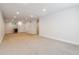 Spacious finished basement with neutral carpet, white trim, and recessed lighting throughout the space at 1911 S Lafayette St, Denver, CO 80210