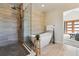 Bright bathroom with a freestanding tub, separate glass enclosed shower and modern fixtures at 1911 S Lafayette St, Denver, CO 80210