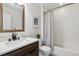 Bathroom featuring a vanity with mirror, tile flooring, and a shower-tub combination with curtain at 1911 S Lafayette St, Denver, CO 80210