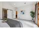 Spacious main bedroom featuring barn doors, ensuite access, and a sitting area at 1911 S Lafayette St, Denver, CO 80210