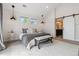 Comfortable bedroom featuring a king bed, two windows, decorative lighting, and ensuite bathroom entrance at 1911 S Lafayette St, Denver, CO 80210