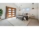 Spacious bedroom with vaulted ceiling, wood doors, and a comfortable sitting area with bench at 1911 S Lafayette St, Denver, CO 80210
