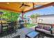 Cozy covered deck with outdoor seating, a grill, and a view of the backyard at 1911 S Lafayette St, Denver, CO 80210