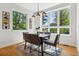 Modern dining room boasts big windows, designer lighting, and seating for six at 1911 S Lafayette St, Denver, CO 80210