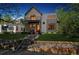 Stunning two-story home with a mix of stone and modern siding, complemented by a well-manicured lawn at 1911 S Lafayette St, Denver, CO 80210
