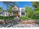 Modern two-story home boasts professional landscaping, a stone facade, and a contemporary design at 1911 S Lafayette St, Denver, CO 80210