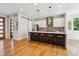 Modern kitchen boasts stainless appliances, bright white cabinets, and a large island with seating at 1911 S Lafayette St, Denver, CO 80210