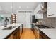 Kitchen with large island, stainless appliances, and a sliding barn door at 1911 S Lafayette St, Denver, CO 80210
