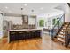 Open kitchen with modern cabinets, large island with seating, and stainless steel appliances at 1911 S Lafayette St, Denver, CO 80210