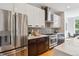 The kitchen features stainless steel appliances and a modern design with dark wood and white cabinets at 1911 S Lafayette St, Denver, CO 80210