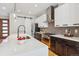 Modern kitchen boasts stainless appliances, bright white cabinets, and a large island with sink at 1911 S Lafayette St, Denver, CO 80210