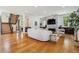 Spacious living room offers modern staircase, fireplace, and views to outside at 1911 S Lafayette St, Denver, CO 80210