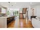Open floor plan features a modern kitchen, a dining area, and a staircase at 1911 S Lafayette St, Denver, CO 80210