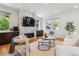 Bright living room features a stone fireplace, recessed lighting, and hardwood floors at 1911 S Lafayette St, Denver, CO 80210
