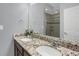 Bathroom vanity features granite countertops, double sinks, and framed mirror reflecting the shower at 17938 E 54Th Ave, Denver, CO 80249