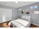 Bright bedroom features hardwood floors, sun-filled windows, and comfortable decor at 17938 E 54Th Ave, Denver, CO 80249