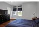Bedroom showcases hardwood floors, gray walls, and a view to the backyard through the window at 17938 E 54Th Ave, Denver, CO 80249