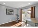 Bright bonus room with exercise bike, French doors, and stylish decor at 17938 E 54Th Ave, Denver, CO 80249