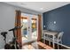 Bright bonus room with french doors leading to private patio and adjacent to dining set and exercise bicycle at 17938 E 54Th Ave, Denver, CO 80249