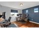 Home office with dual monitor setup, hardwood floors and an ergonomic chair for optimal productivity at 17938 E 54Th Ave, Denver, CO 80249