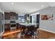 Modern kitchen with stainless steel appliances, a center island with seating, and dark wood cabinets at 17938 E 54Th Ave, Denver, CO 80249