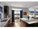 Stylish kitchen featuring a center island, dark wood cabinets, stainless steel appliances and a backyard view at 17938 E 54Th Ave, Denver, CO 80249