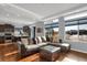 Bright living room showcasing hardwood floors, a modern sectional couch, and an open concept kitchen at 17938 E 54Th Ave, Denver, CO 80249