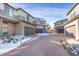 Street view of homes featuring a brick paved driveway and sidewalks with small landscaped bushes at 17938 E 54Th Ave, Denver, CO 80249