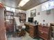 Finished basement with built-in bookshelves, desk, and stained glass window details for a unique aesthetic at 6005 S Jamaica Way, Englewood, CO 80111
