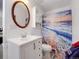Bright bathroom featuring a single sink vanity, built in cabinet, and a decorative ocean themed shower curtain at 6005 S Jamaica Way, Englewood, CO 80111