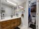 Cozy bathroom with a single sink vanity and framed mirror at 6005 S Jamaica Way, Englewood, CO 80111