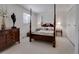 Cozy bedroom with a four-poster bed, matching nightstands, and a window at 6005 S Jamaica Way, Englewood, CO 80111
