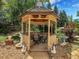 A lovely gazebo provides a relaxing outdoor space amidst beautiful garden surroundings at 6005 S Jamaica Way, Englewood, CO 80111