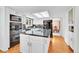 Modern kitchen featuring white cabinets, a large island, and built-in appliances at 6005 S Jamaica Way, Englewood, CO 80111