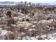 Stunning aerial view of snow-covered residential neighborhood and city skyline in the distance at 425 Monroe St, Denver, CO 80206