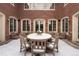 Brick backyard patio with chairs and table covered in snow, surrounded by snow-covered landscaping at 425 Monroe St, Denver, CO 80206