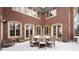 Brick backyard patio with chairs and table covered in snow, surrounded by snow-covered landscaping at 425 Monroe St, Denver, CO 80206