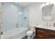 Modern bathroom with glass-enclosed shower, beautiful tiling, stylish vanity and marble countertops at 425 Monroe St, Denver, CO 80206