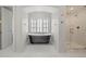 Well-appointed bathroom with a freestanding tub, tiled floor, and glass shower at 425 Monroe St, Denver, CO 80206