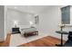 Bright bedroom featuring hardwood floors, area rug, and a cozy decor with bench at foot of bed at 425 Monroe St, Denver, CO 80206