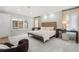 Bright bedroom with a wooden bed frame, large windows, and light gray carpet at 425 Monroe St, Denver, CO 80206