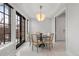 Cozy dining area with a modern light fixture, black-framed windows, and neutral decor at 425 Monroe St, Denver, CO 80206