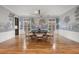 Elegant dining room with a designer chandelier, large windows, hardwood floors, and scenic wallpaper at 425 Monroe St, Denver, CO 80206