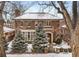 Charming brick home featuring a manicured front yard, mature trees, and a classic architectural design at 425 Monroe St, Denver, CO 80206