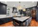 Modern kitchen boasting a large island, stylish pendant lighting, stainless steel appliances, and ample counter space at 425 Monroe St, Denver, CO 80206