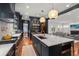 Open-concept kitchen featuring an oversized island, high-end appliances, and seamless flow to the living area at 425 Monroe St, Denver, CO 80206