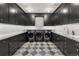 Modern laundry room with sleek cabinetry, counter space, and modern appliances at 425 Monroe St, Denver, CO 80206