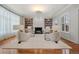 Elegant living room with a fireplace, custom built-ins, hardwood floors, and large windows for natural light at 425 Monroe St, Denver, CO 80206